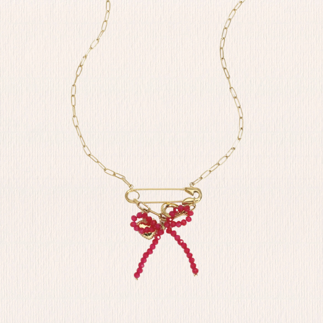 Gouden schakelketting met roze strik