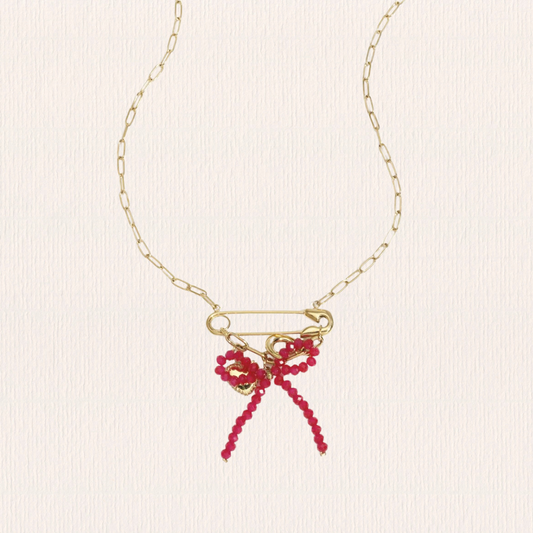 Gouden schakelketting met roze strik