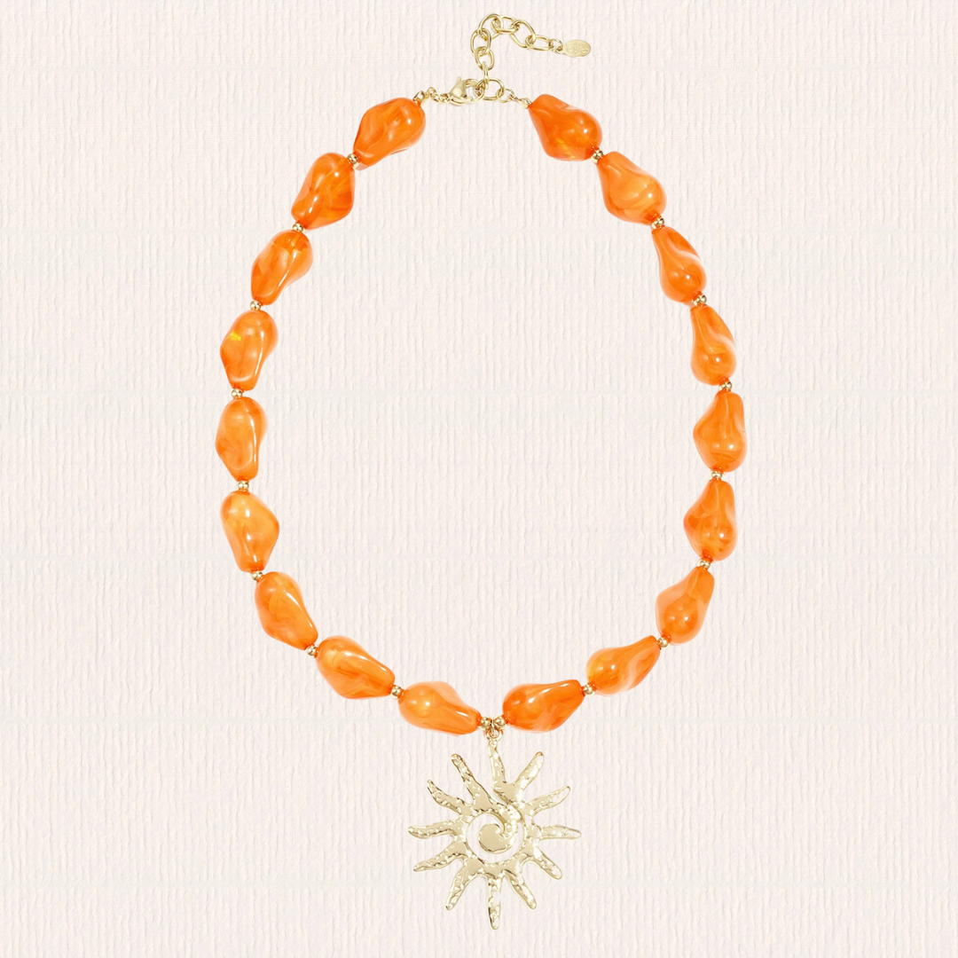 Oranje kralenketting met zon bedel