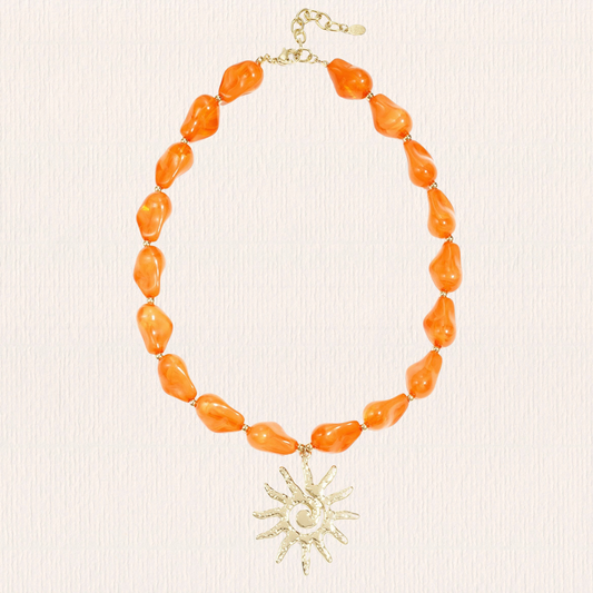 Oranje kralenketting met zon bedel