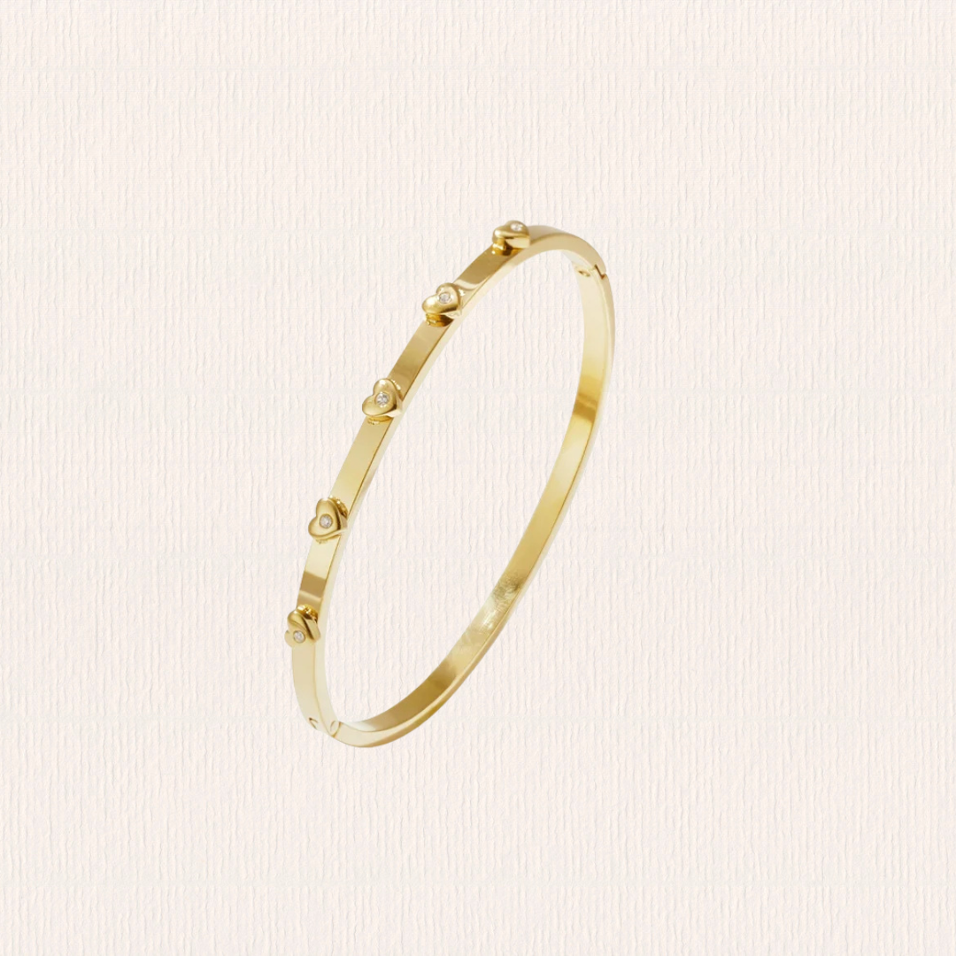 Gouden bangle met hartjes studs